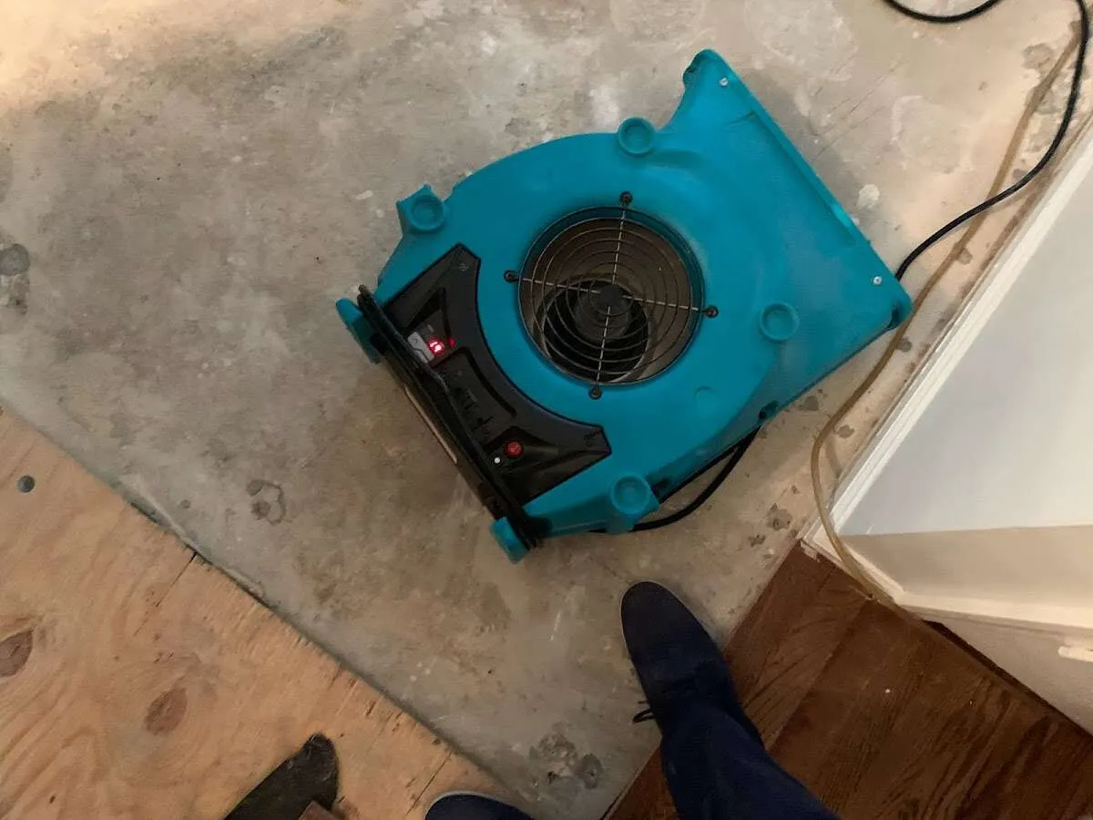 Air mover drying subfloor during Commercial Water Damage Restoration in Herndon